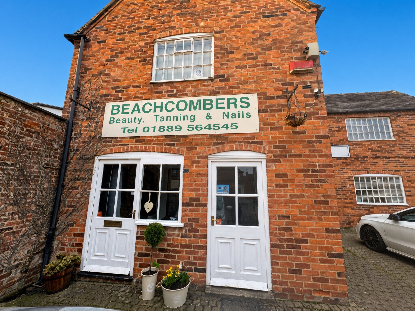 The red-brick frontage of Beachcombers in Uttoxeter, with white doors and a painted sign