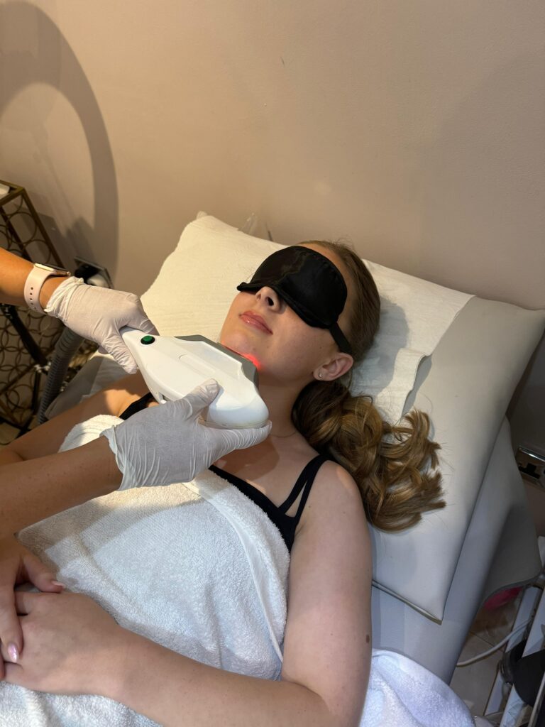 A client resting with eye protection during an IPL treatment at LeyaNova